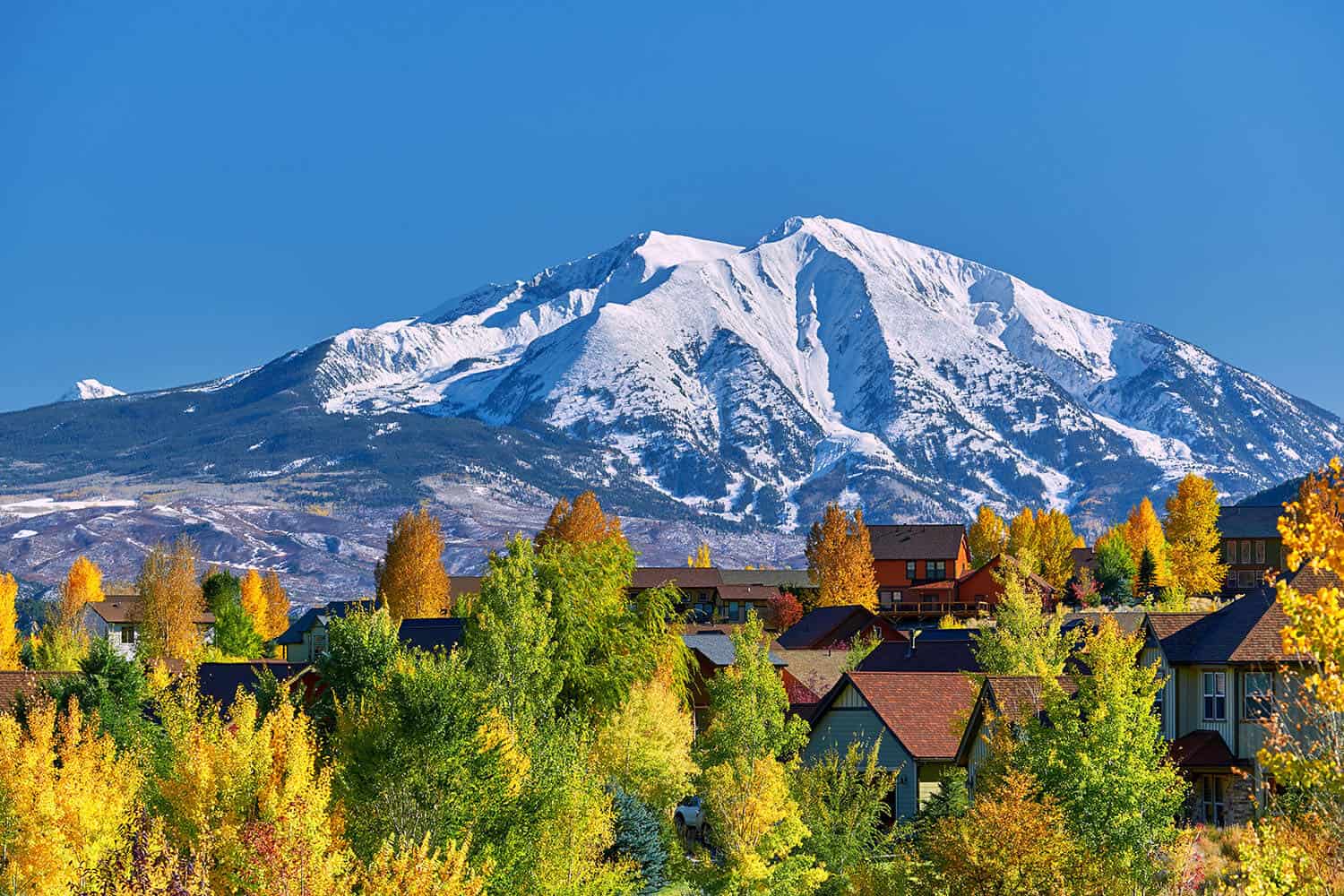 Colorado town with snow capped mountain in the background